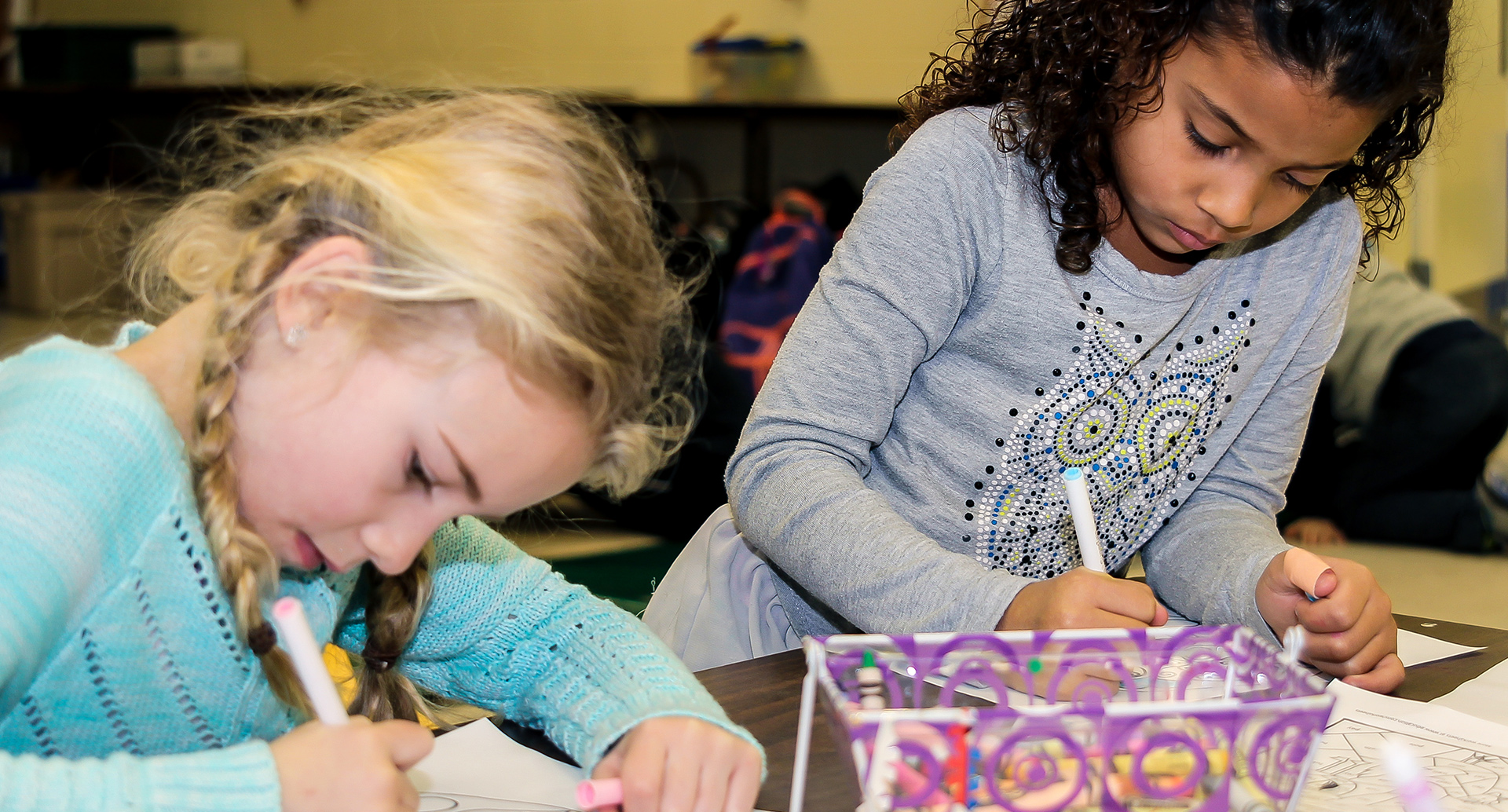 Two girls colouring