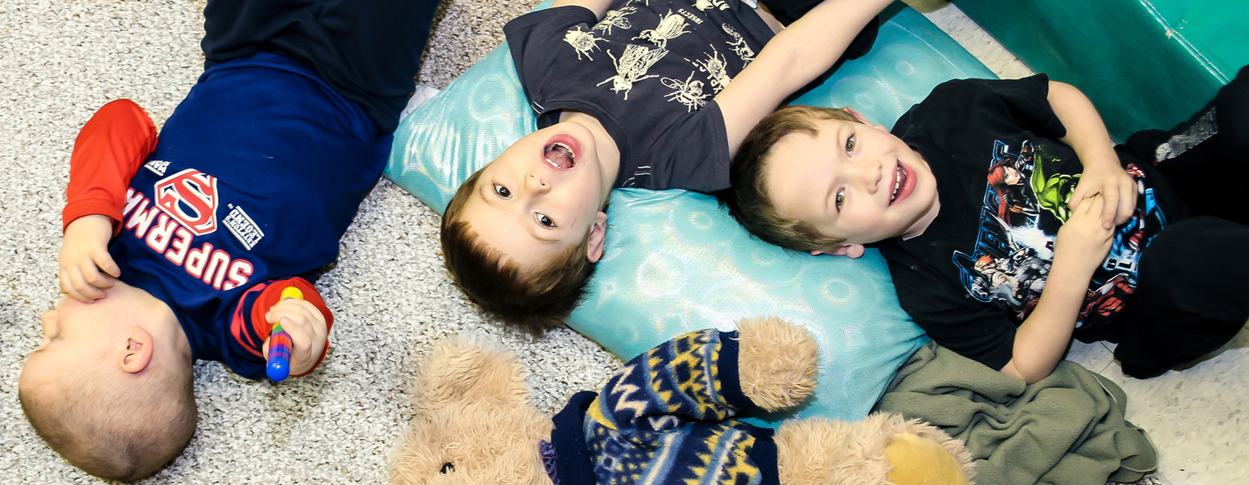 Boys lying on carpet